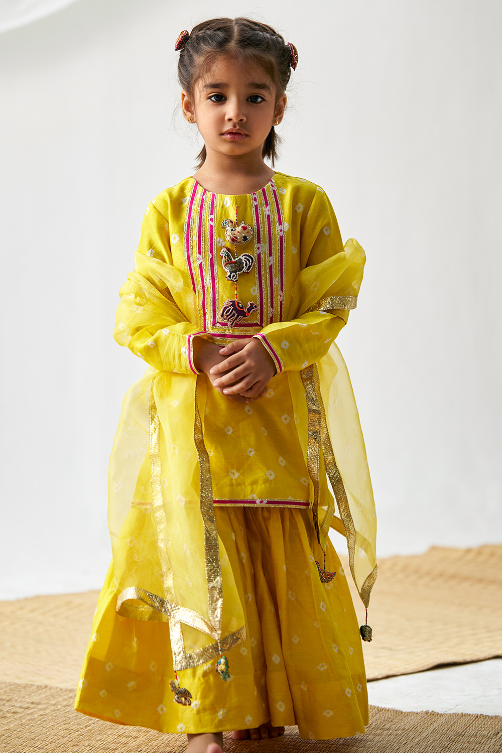 Yellow Kurta Which Has Gota Stripes And Animal Tassels On The Neckline Paired With Sharara And Dupatta