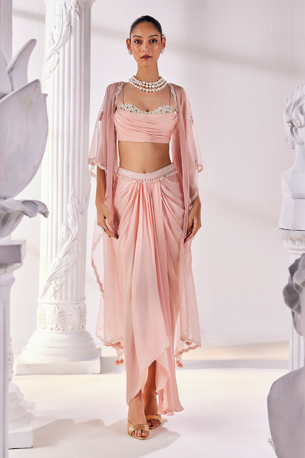 Peach Draped Skirt With a Belt And a Pearl Detailed Blouse With A Soft Organza Cape